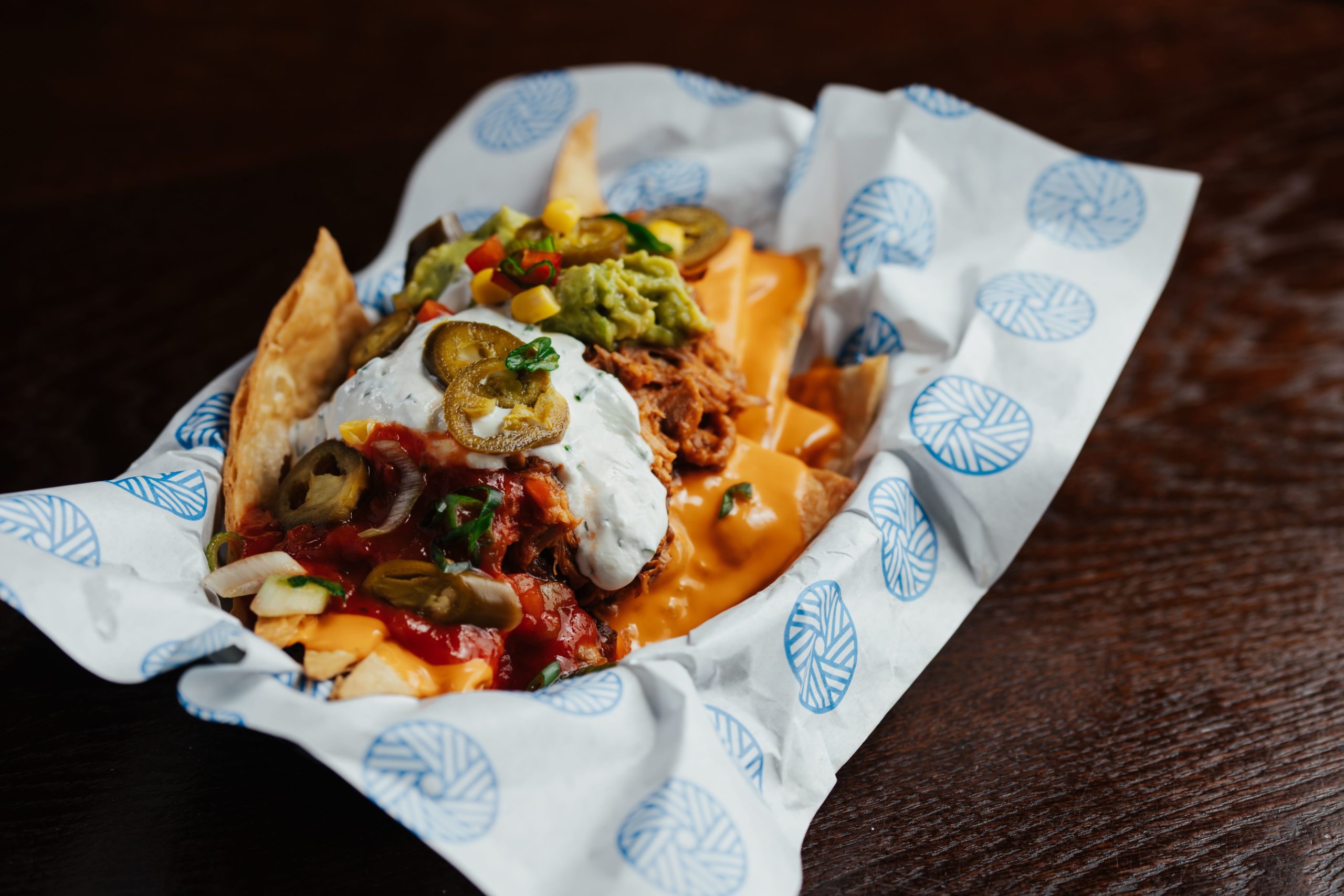 Homemade nachos with guacamole, sour cream, chilli and jalapeños served from The Old Grindstone kitchen